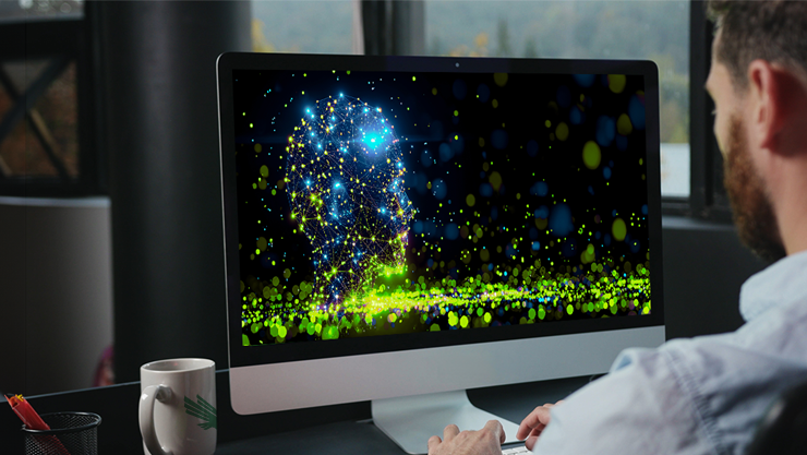 A man working on a computer displaying a digital neural network map