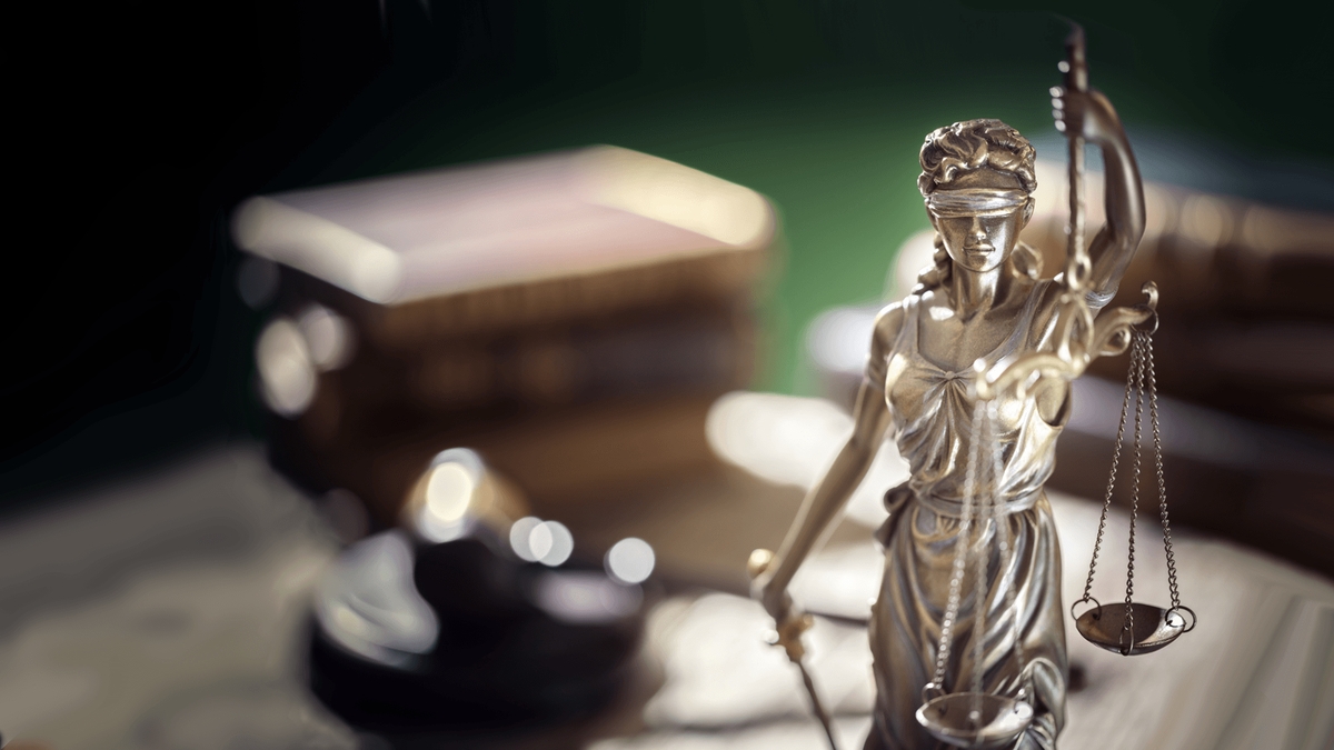 A close-up of a Lady of Justice statue with scales