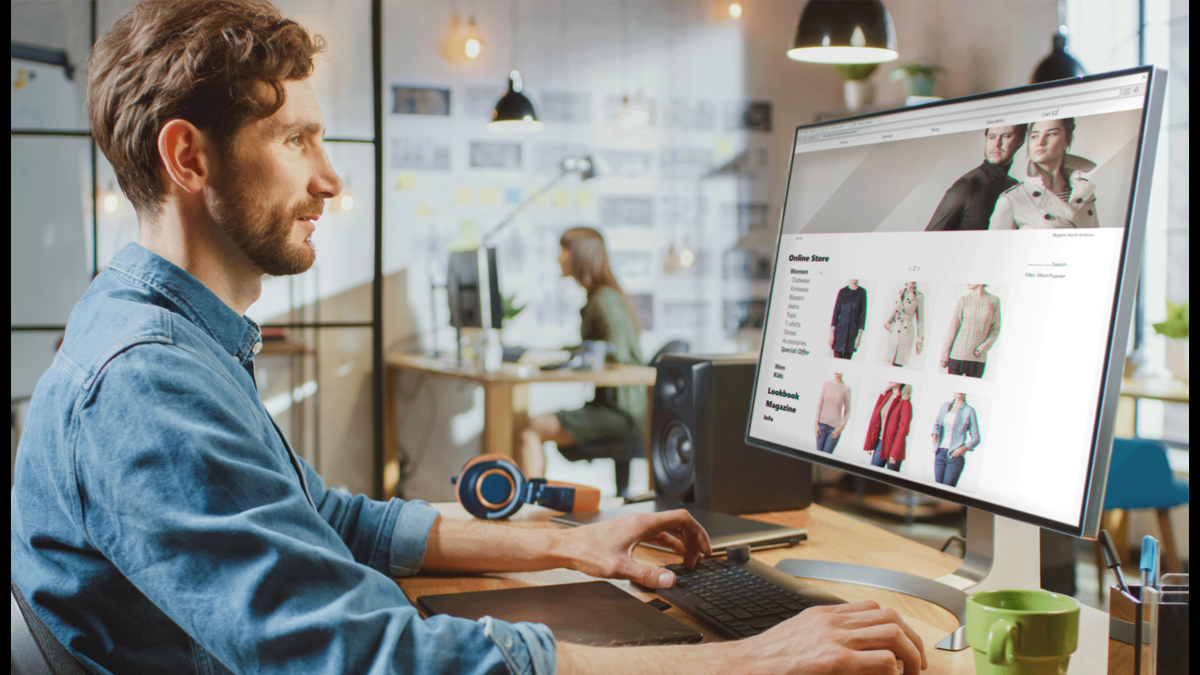 A professional analyzing online retail data on a large computer screen in office