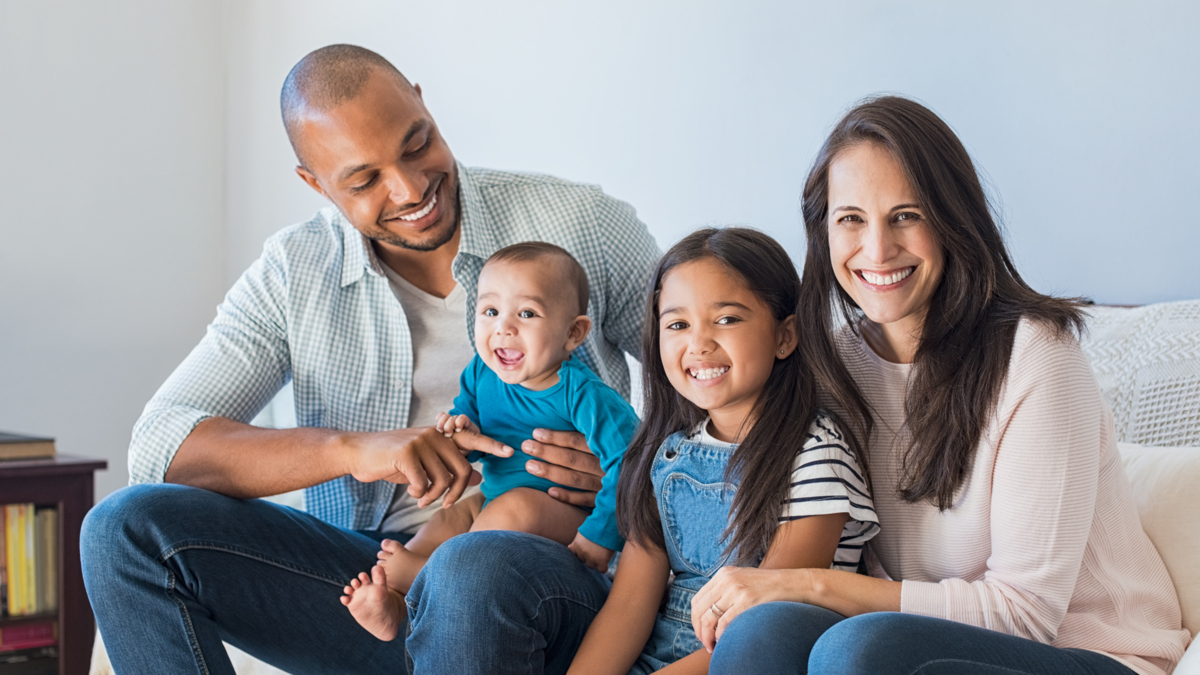 A happy family sitting together on a couch