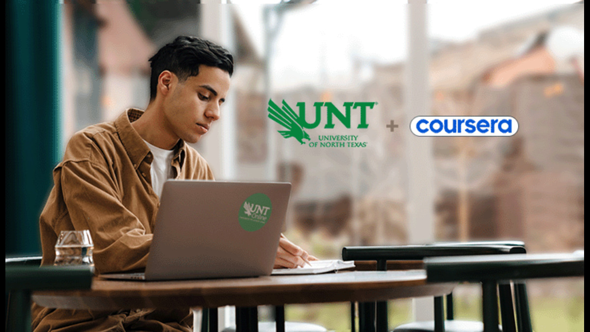 A student studying with a laptop featuring a UNT logo