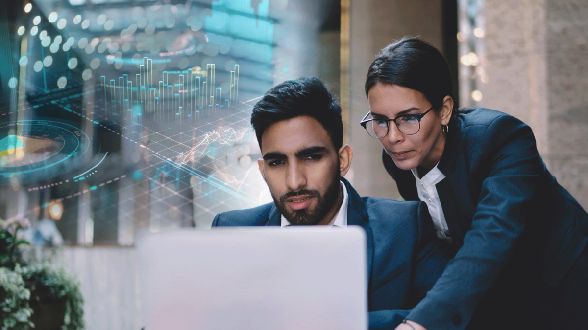 Two business professionals focusing on a laptop screen