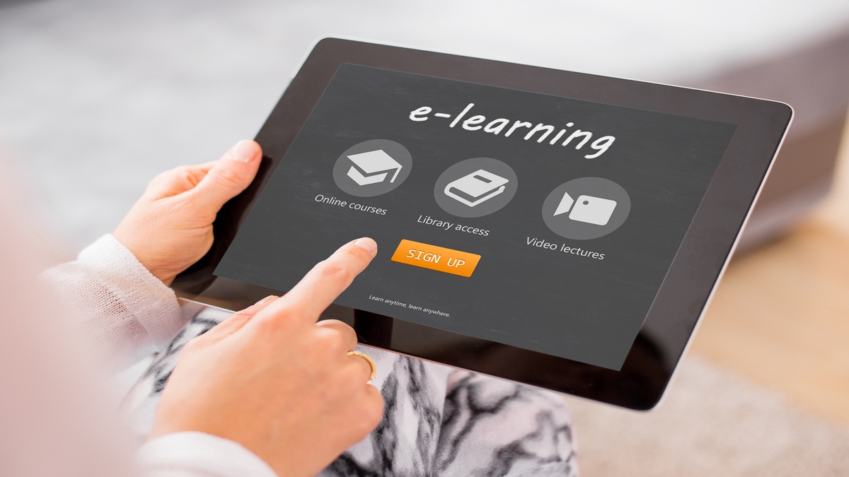 A close-up of a hand selecting an e-learning course option on a tablet