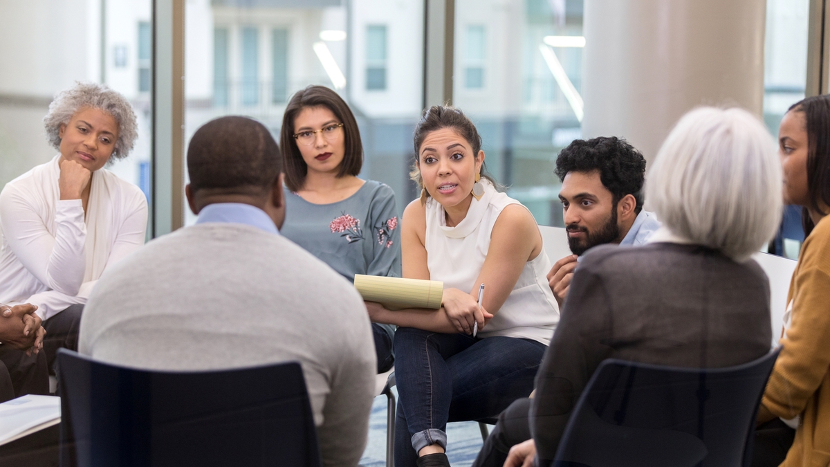 A faciliator leading a group support session