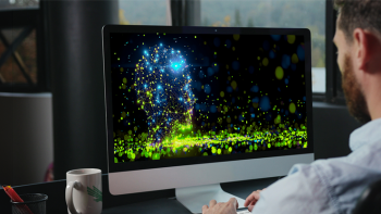 male professional working with an artistic depiction of artificial intelligence on a computer screen 