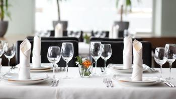 wine glasses and silverware placed on a table top