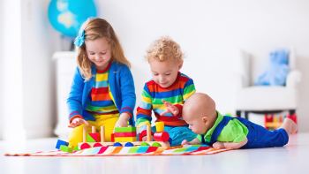 preschooler, toddler and infant playing with blocks